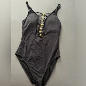 Rod Beatte Bleu 10 women swimsuit in black with gold color clips on front